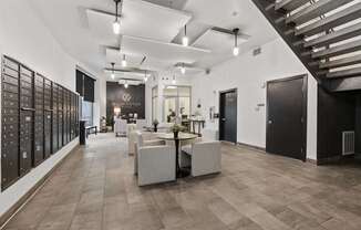 A spacious interior with a staircase on the right and a long wall of mailboxes on the left at Wilmington Flats Apartments, Salt Lake City, Utah