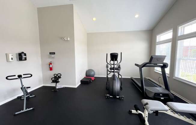 a gym with treadmills and other exercise equipment in a building at Traditions at Slate Ridge, Reynoldsburg