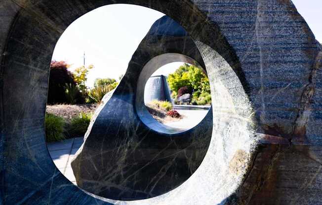 A person is walking through a circular stone structure at Spyglass Hill Apartments, Bremerton, 98337