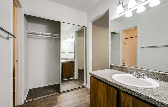 the interior of a bathroom with a sink and a mirror