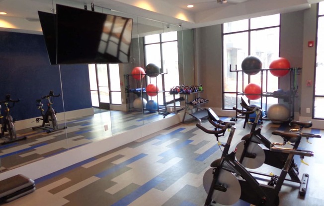 a gym with a tv and exercise equipment