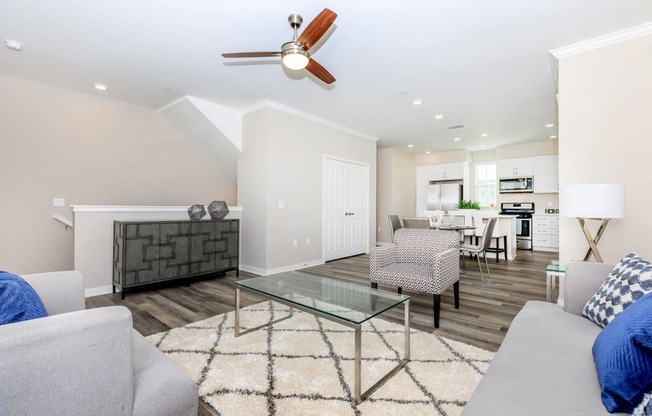 a living room with couches and a glass coffee table