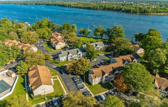 an aerial view of a neighborhood with a lake in the background