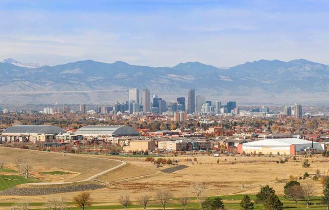 A cityscape with a mountain range in the background.