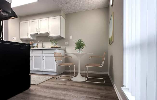 A kitchen with a black counter and white cabinets.