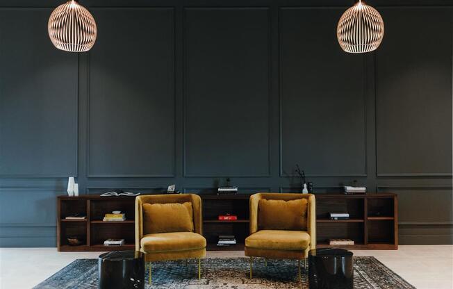 a room with two yellow chairs and a rug