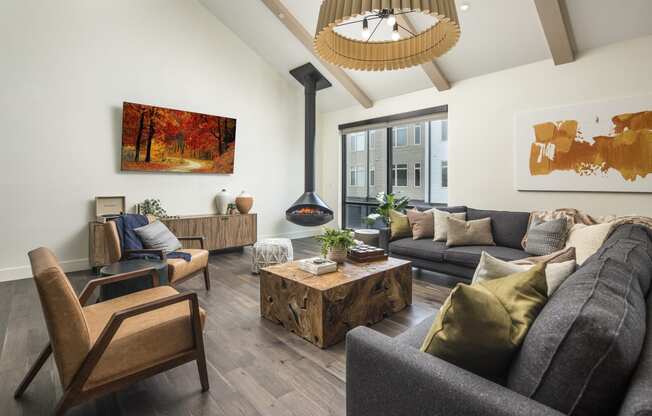 a living room with couches chairs and a coffee table and a fireplace