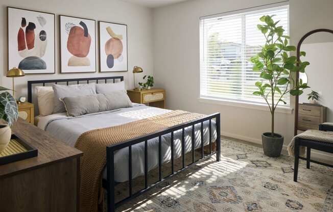 a bedroom with a large bed and two paintings on the wall