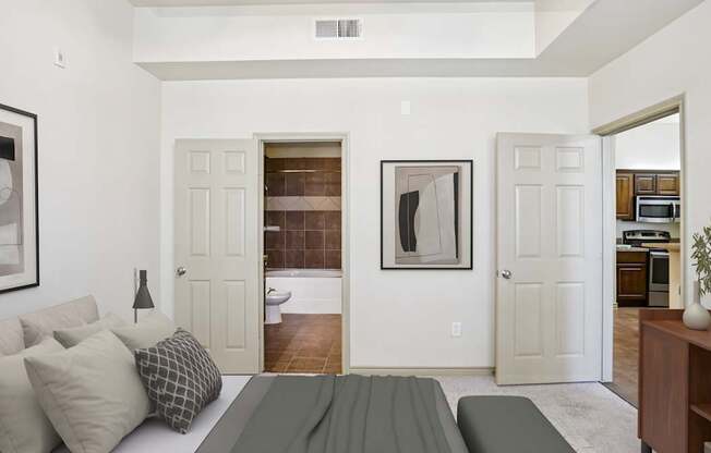 A living room with a grey couch and a painting on the wall.