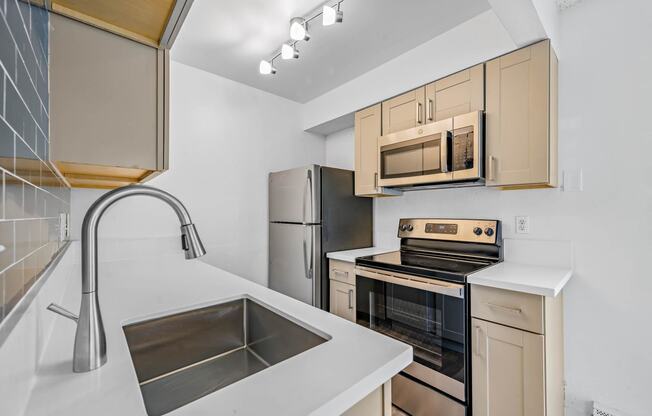 a kitchen with wood cabinets and stainless steel appliances