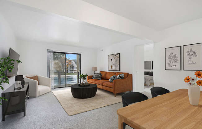 A living room with a brown sofa and a wooden table at North Pointe Apartments, Elkhart