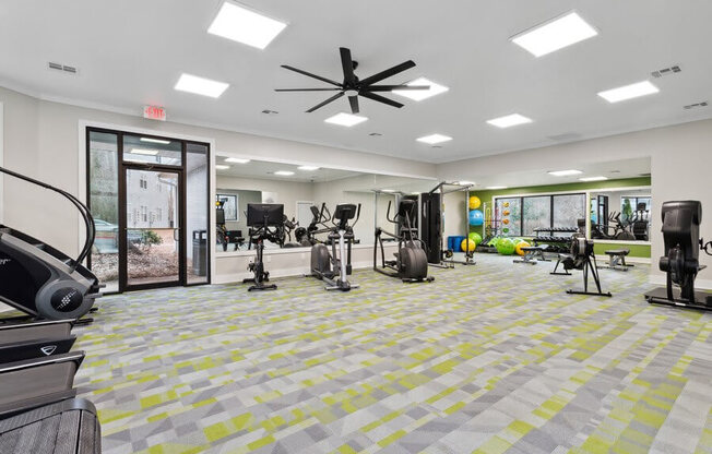Community Fitness Center with Equipment and Mirrors at Element 41 Apartments in Marietta, GA.