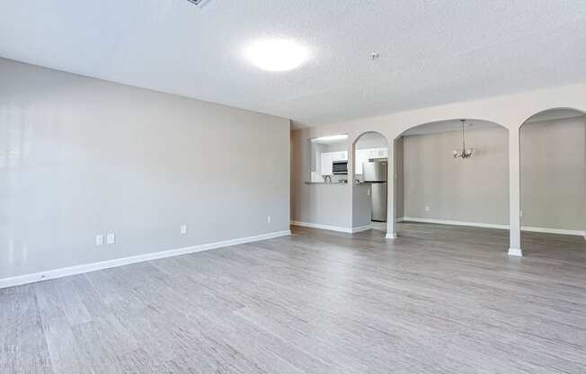 A spacious room with light grey flooring and white walls.