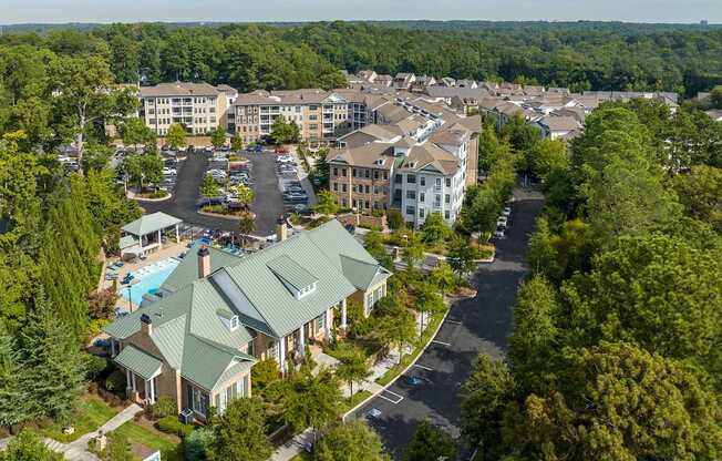 A bird's eye view of a resort with a swimming pool and a large building.