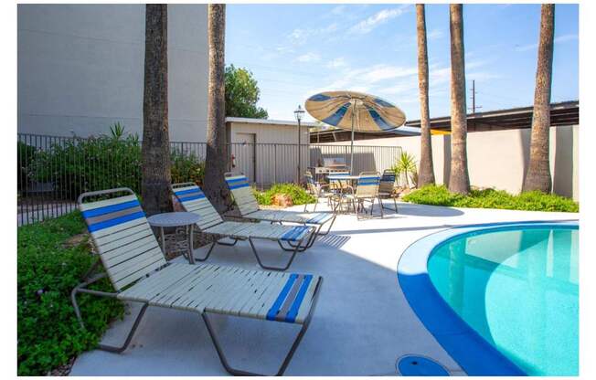 A pool with a blue and white striped sun lounger.