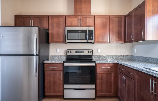 a kitchen with wooden cabinets and stainless steel appliances