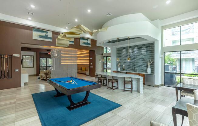 a living room filled with furniture and a pool table