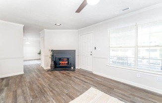 a living room with a fireplace and a window