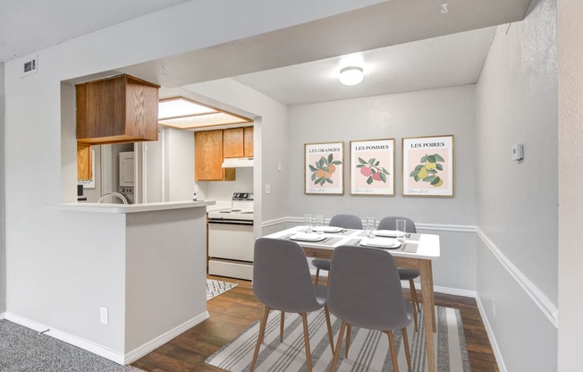 a dining room with a table and chairs and a kitchen