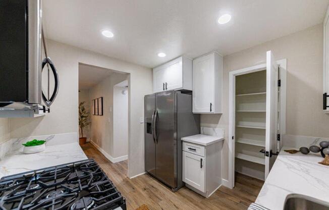 a kitchen with a stainless steel refrigerator and a counter top