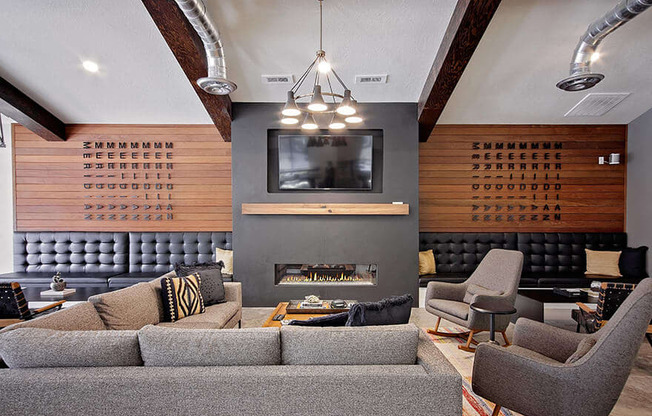 Cluhouse lounge seating, fireplace and wall tv