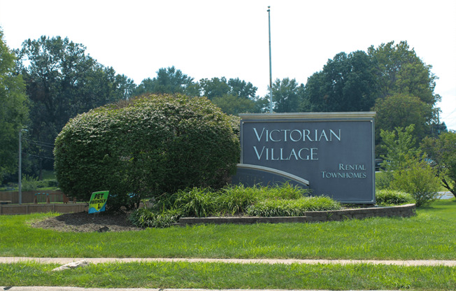 the welcome sign for Victorian Village Townhomes