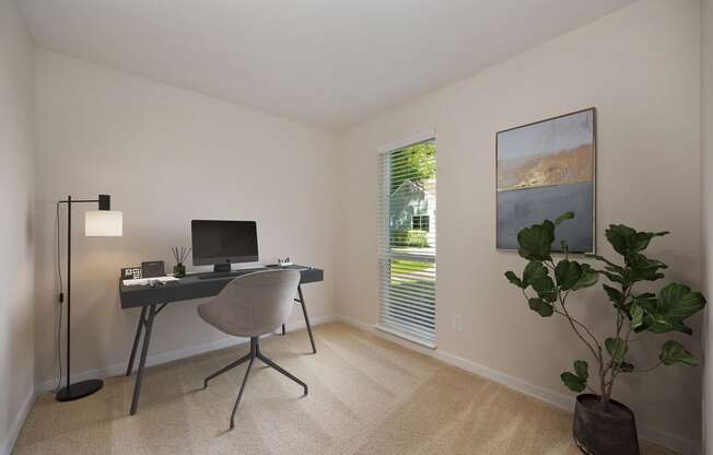 a home office with a computer desk and a plant in a room with a window