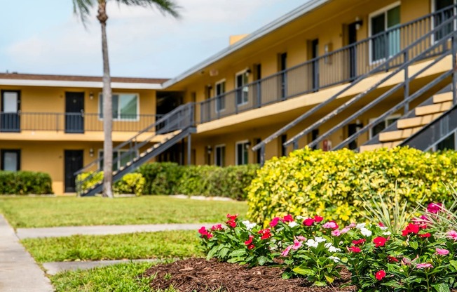 a picture of a building with flowers in front of it