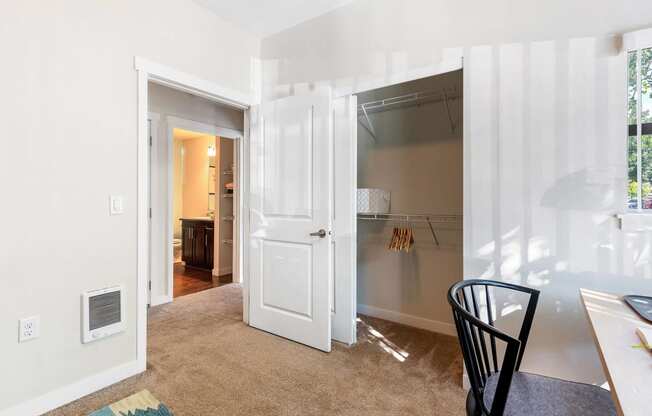 a bedroom with a closet and a desk with a chair at Mullan Reserve Apartments, Missoula