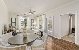 A living room with a dining table and chairs.