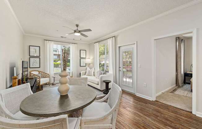 A living room with a dining table and chairs.