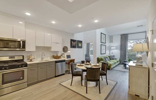 a kitchen and living room with a table and chairs