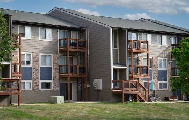 Apartment building with balconies and a clear sky in the background.