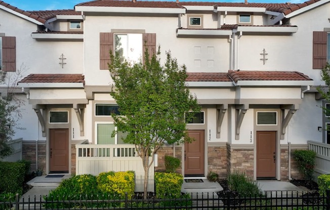 A white house with brown doors and windows.