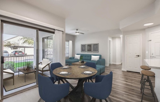 a living room and dining room with a table and chairs