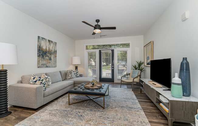 a living room with a couch a coffee table and a tv