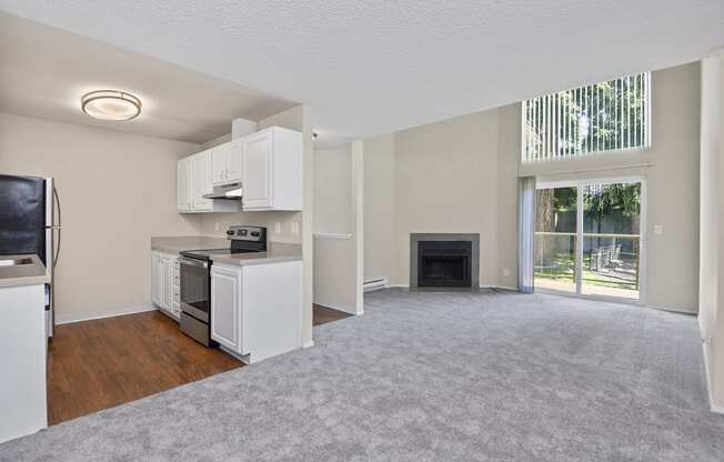 a living room with a fireplace and a kitchen