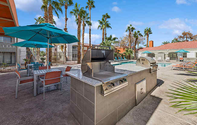 Outdoor BBQ Area with Picnic Tables at Stonegate Apartments located in Las Vegas, NV.