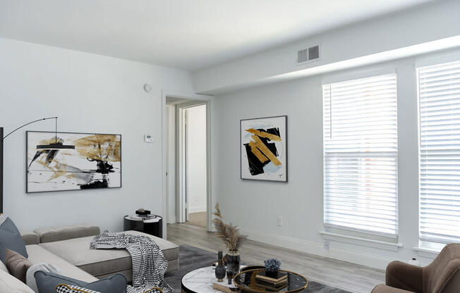 a living room with gray walls and white trim