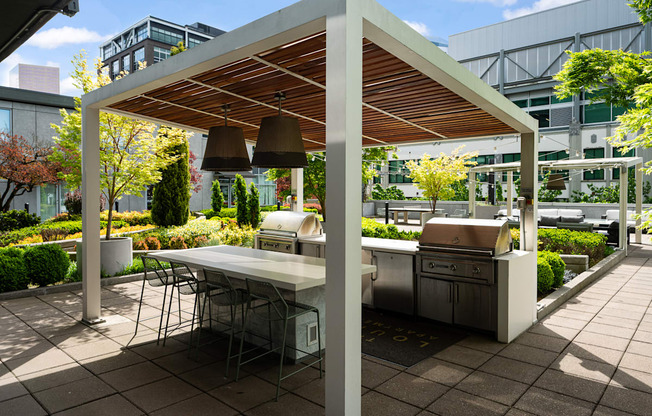 A patio with a table and chairs under a roof.