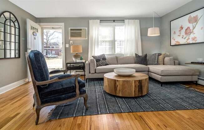 Living room lit up with natural light featuring wood plank flooring