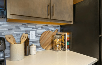 a kitchen with a counter top and a refrigerator at The Cosmopolitan, St Paul