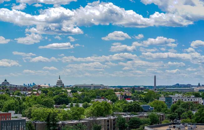 Wide-reaching views from Modera H Street showcase the DC skyline, with landmark silhouettes rising above tree-lined neighborhoods and city streets.