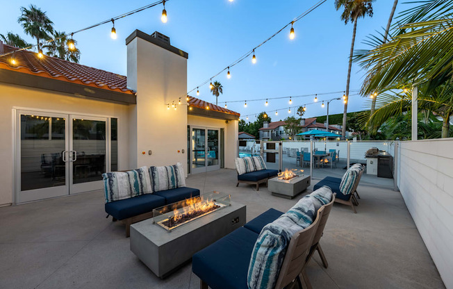 a patio with couches and chairs and a fire pit  at Laguna Gardens Apts., Laguna Niguel, CA, 92677