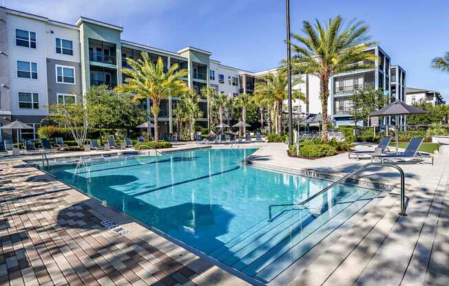 a swimming pool in front of an apartment building