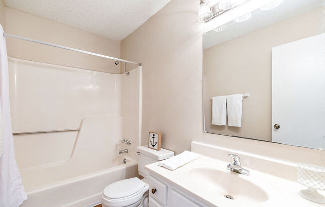 Classic Bathroom with White Vanity and Almond Color Countertop