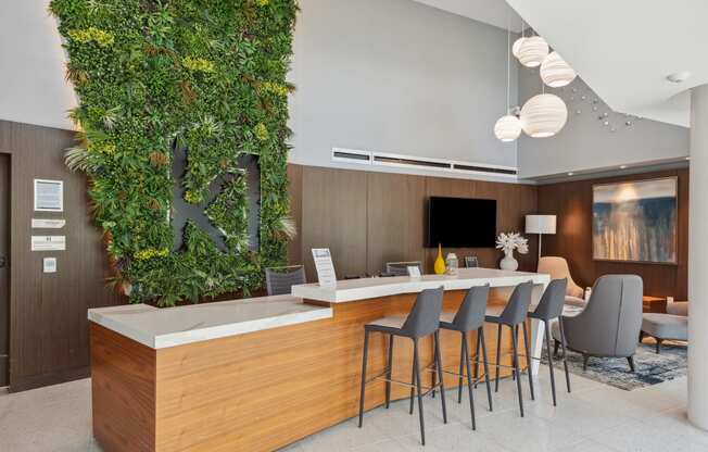 a living wall in a restaurant with a bar and chairs