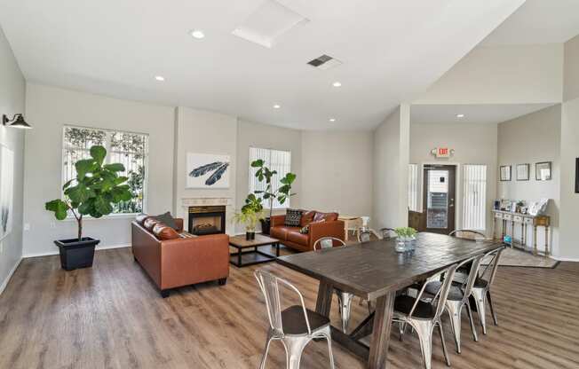 a living room with a table and chairs and a fireplace