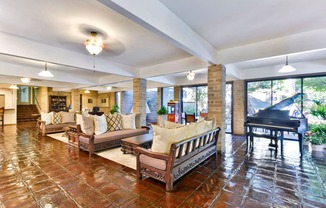 a large living room with furniture and a piano