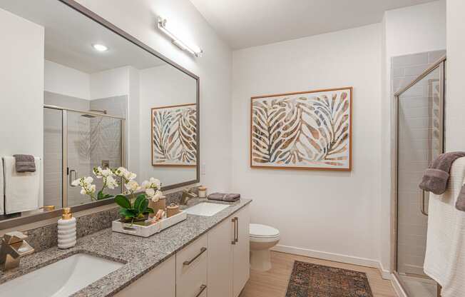 a bathroom with a large mirror and two sinks